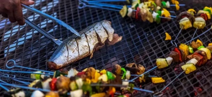 Fish and kebabs on a grill at Turneffe Island Resort